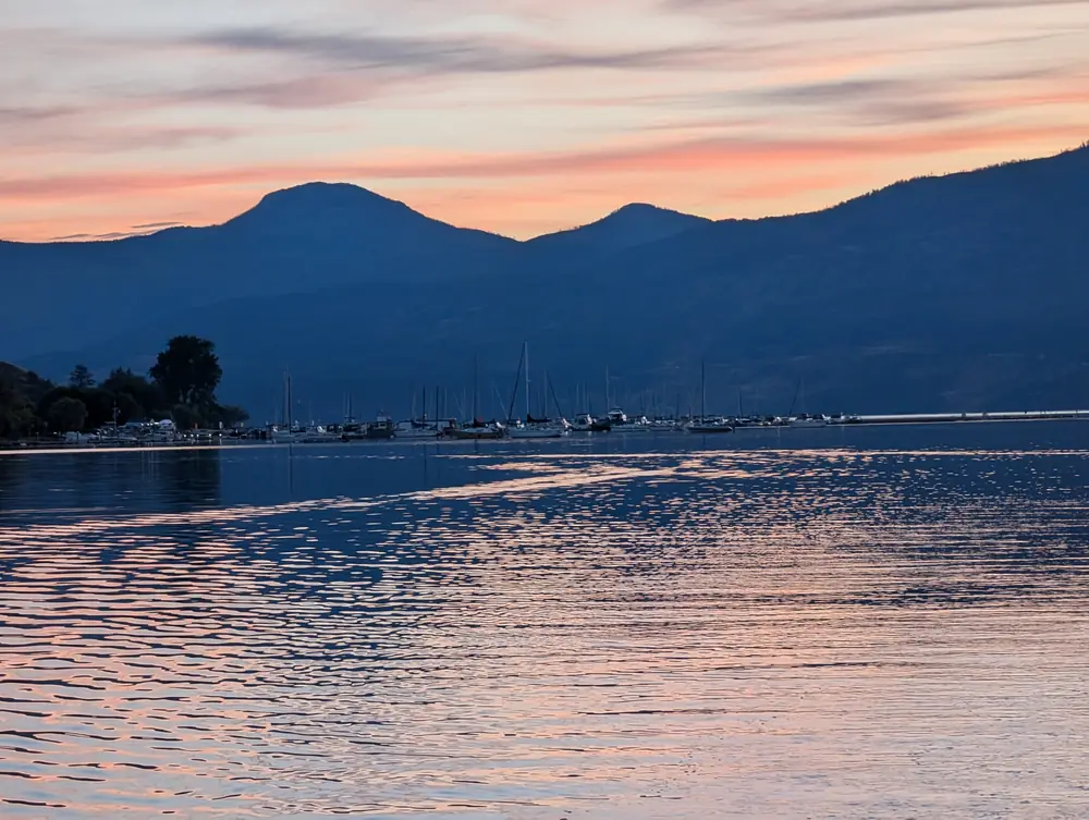 Pink and blue sunset sky over the mountains and Okanagan Lake, September 17, 2024, 7:11 p.m.