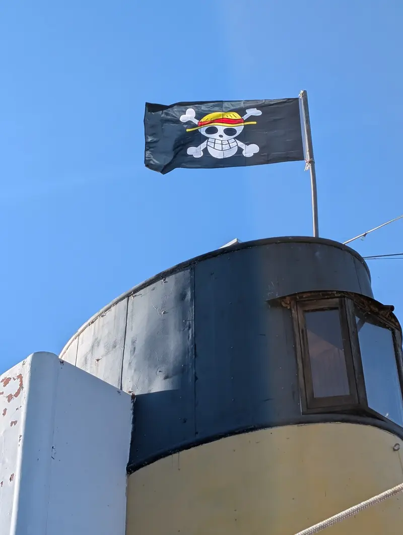 The Jolly Roger flying from the funnel of the MV Okanagan tug on pirate party day